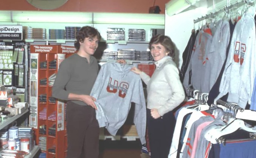 Students hold up merchandise in the UC Clermont Bookstore, 1983.